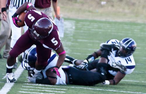 Running back Kelvin Thompson gets tackled by a Tarleton defensive player. Photo by Stephen Ingle.