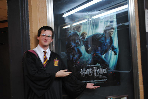 WT Student, cosplaying as Harry Potter, next to the Harry Potter and the Deathly Hallows poster.