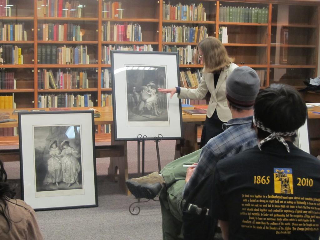 Dr. Von Lintel reviews paintings with her class. Photo courtesy of Valerie Roberts.