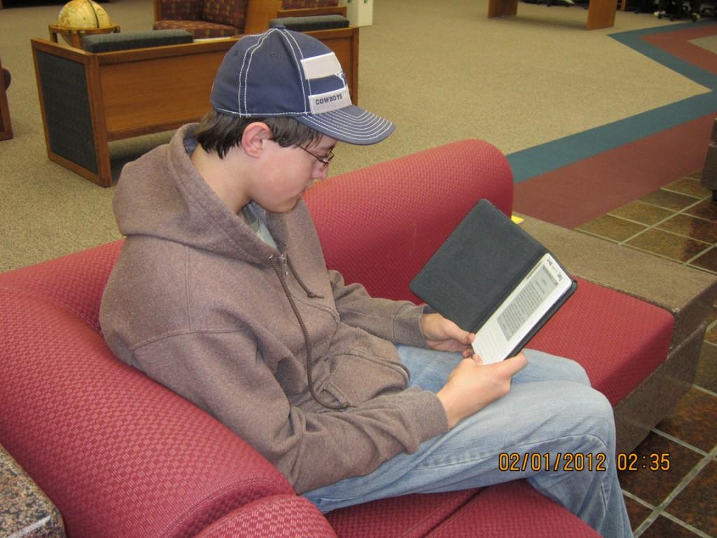 Heath Newkirk, a junior engineering technology major, using a kindle at the library. Photo by Taylor Hurst.