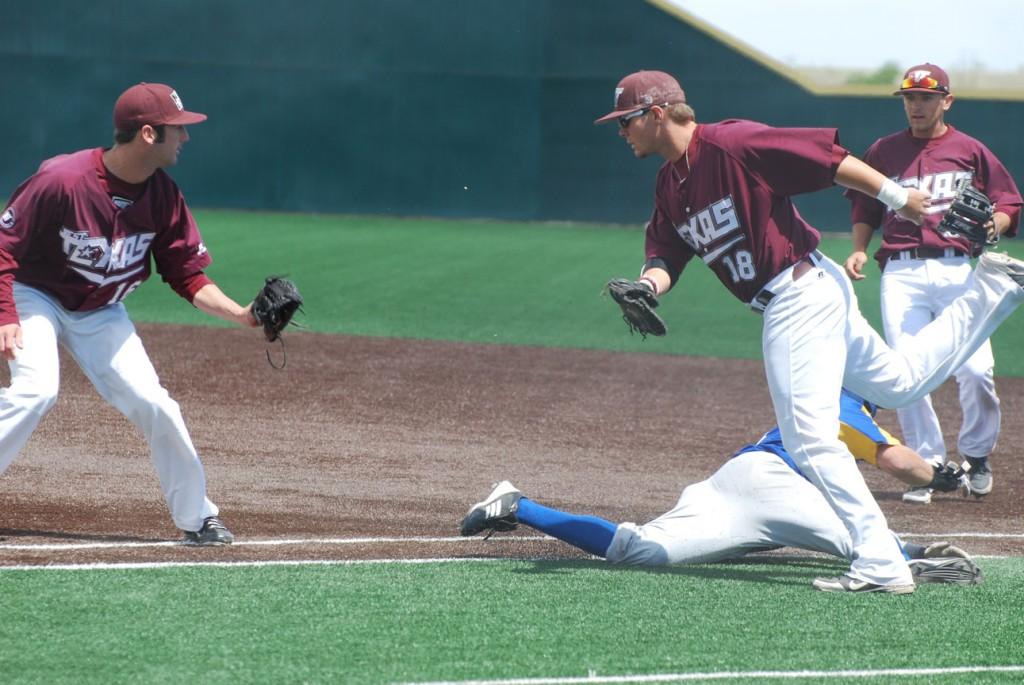 Justin Kuks, Parker Wood and Cody Wright try to tag out the runner. Photo by Melissa Bauer-Herzog.