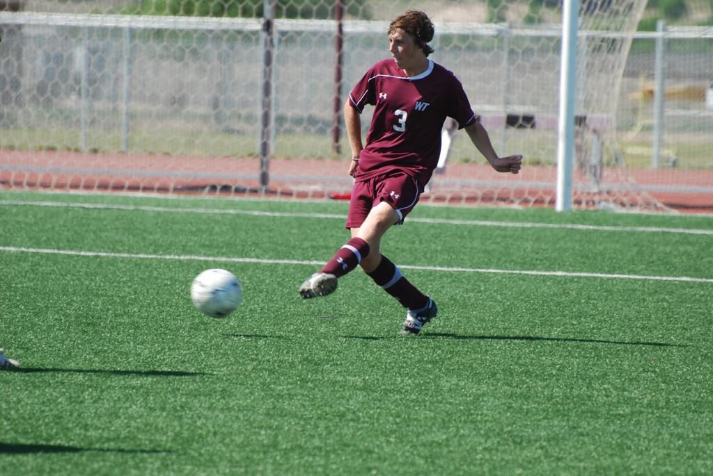 Mikey Williams sends the ball down the field. Photo by Melissa Bauer-Herzog.