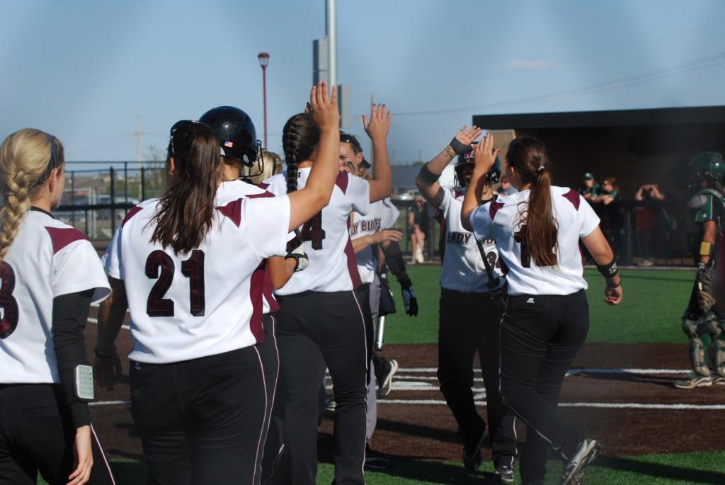 The Lady Buffs celebrate after their first run of the third inning.  Photo by Melissa Bauer-Herzog.