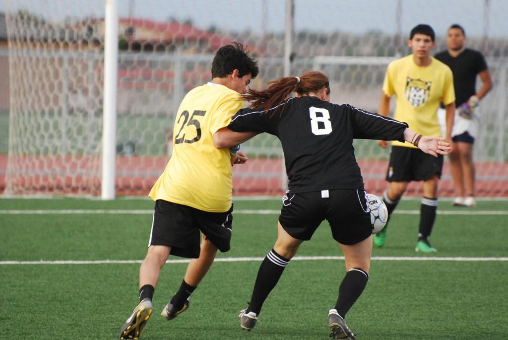 One of the teams the Lady Buffs faced during spring season was the Amarillo Lightning. Here, Kelsey Wright (#8) fights one of the players off the ball. Photo by Melissa Bauer-Herzog.