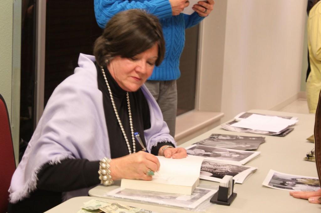 Mary Badham sings books and pictures after ther lecture. Photo by Megan Moore.