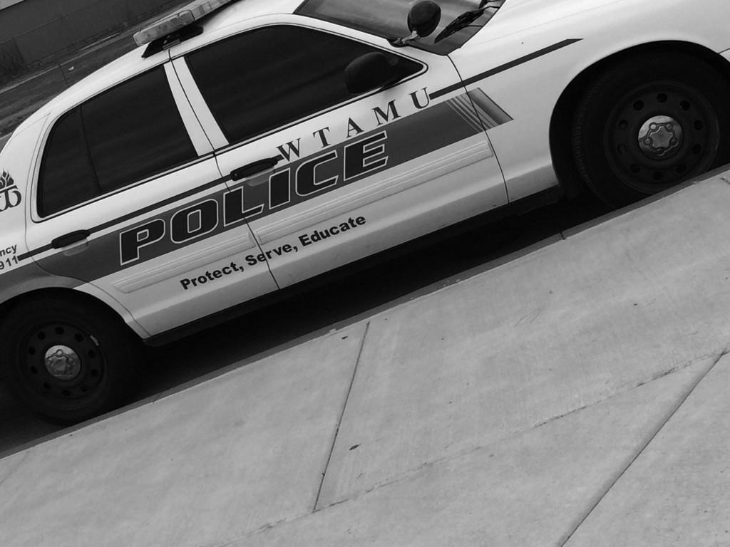 WTAMU campus police car is parked next to curb.